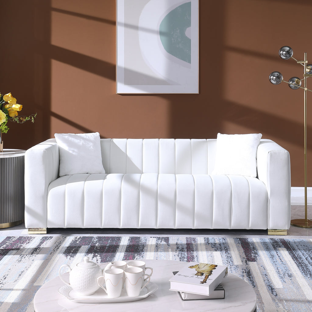 White sofa in a living room with a coffee table and decorative items.
